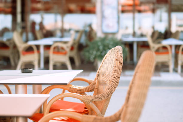 istock Wicker chairs at a table of a street cafe 1177363825