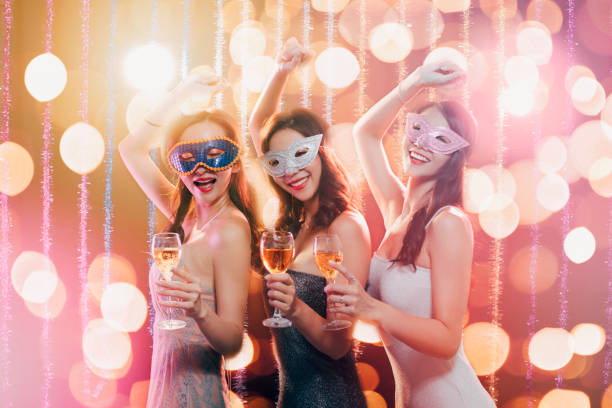 istock happy young group celebrating New Year and drinking champagne on masquerade party 1177366492
