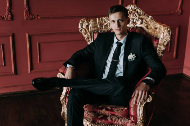 istock Groom in a suit holding buttonhole 1177369362