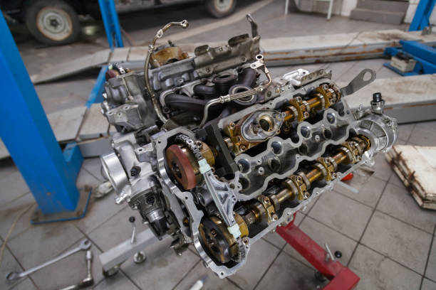 istock Used v8 engine mounted on a crane for installation on a car after a breakdown and renew in a vehicle repair workshop as a guarantee for the dealership. Auto service industry. 1177370286