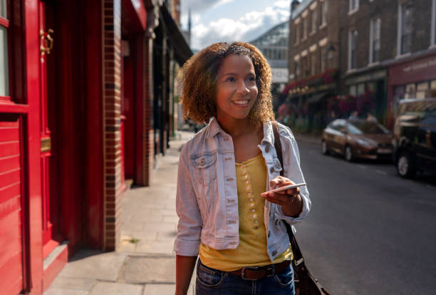 istock Woman using her cell phone on the street 1177370397