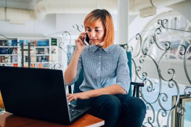 istock Young Woman Sitting In Bookstore And Using Laptop 1177375595