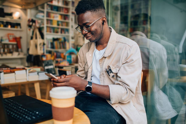 istock Young Man Sitting In Coffee Shop And Using Laptop 1177375621