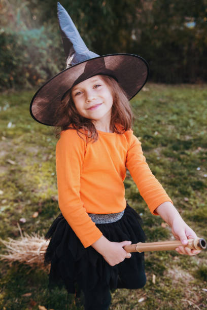 istock Little girl in a witch Halloween costume, having fun 1177378094