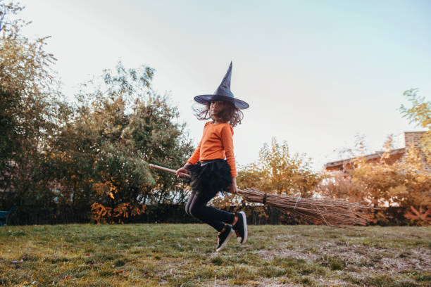 istock Little girl in a witch Halloween costume, having fun 1177378427