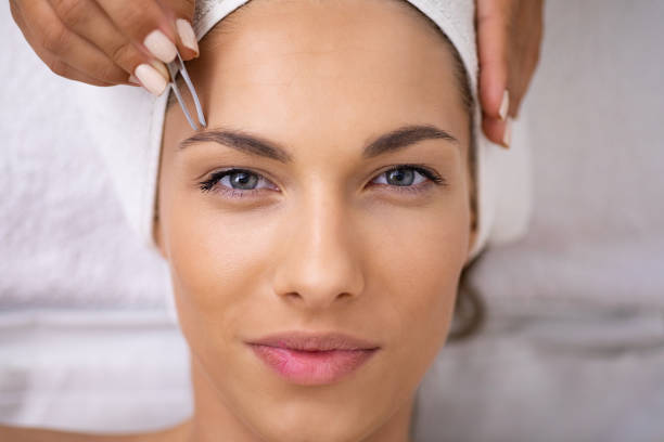 istock Beautiful young woman gets eyebrow correction procedure 1177380510