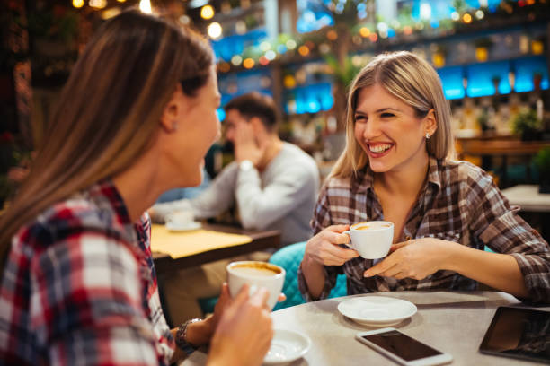 istock Two cheerful women having fun during coffee time in a cafe 1177381010