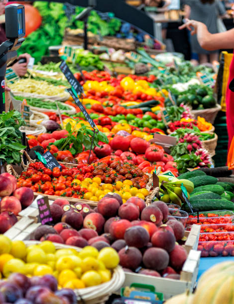 Market Stall Selling Fresh Fruit and Vegetables French market stall selling fruits and vegetables. vegetable stand stock pictures, royalty-free photos & images