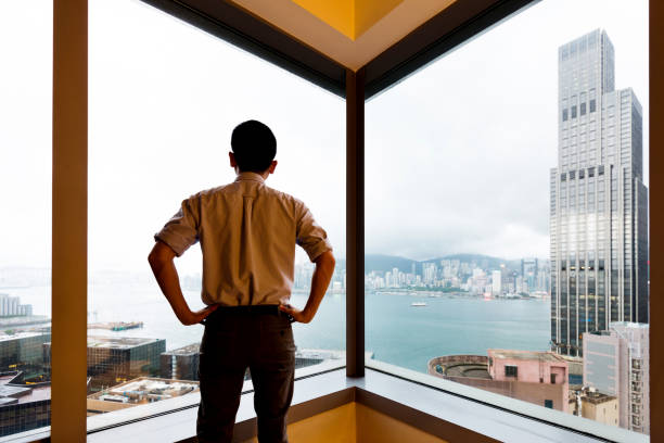 istock Businessman looking at city through office window 1177384989