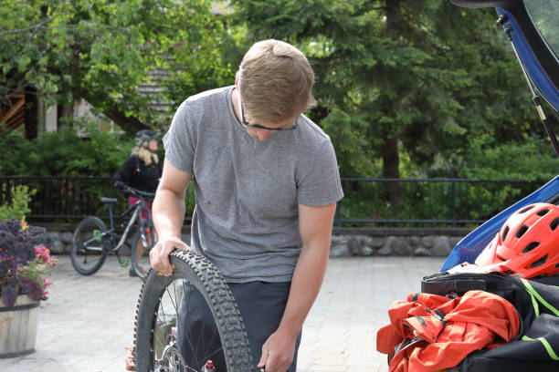 istock Mountain biker adjusts wheels on bike before riding 1177385393