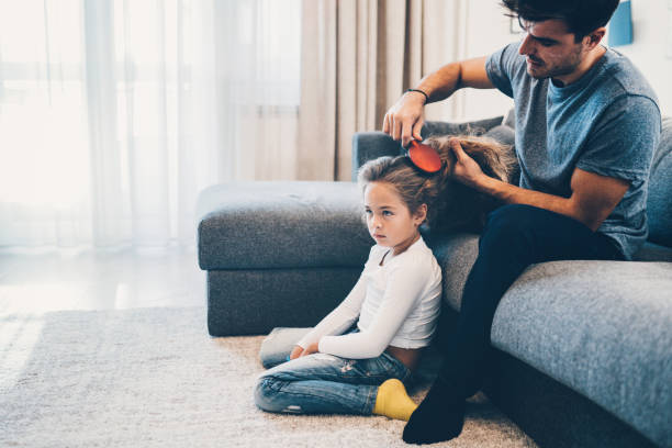 istock Handsome father brushing hair of daughter 1177387590