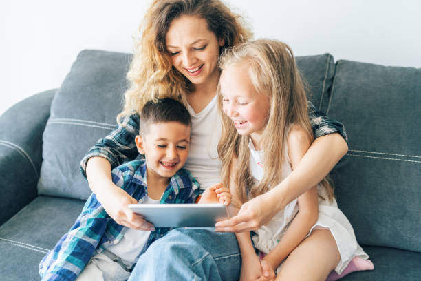 istock Mother and children looking at digital tablet 1177387623