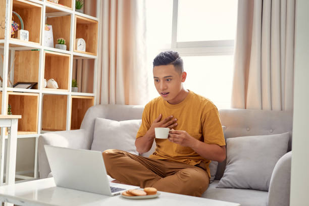 istock happy young Man sitting in sofa and using laptop 1177388331