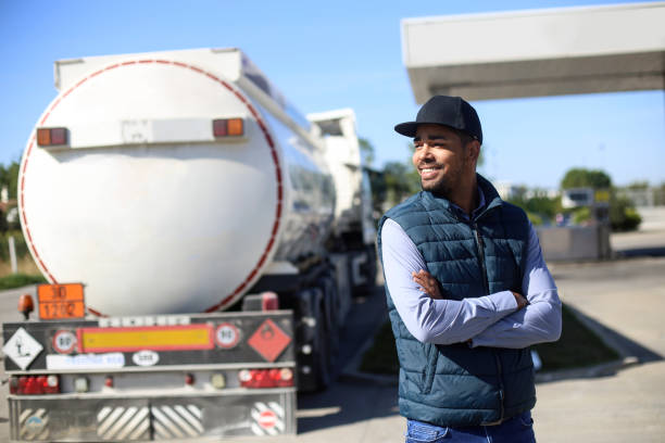 Fuel tanker driver Fuel tanker driver on a gas station. About 35 years old, African male. fuel truck photos stock pictures, royalty-free photos & images