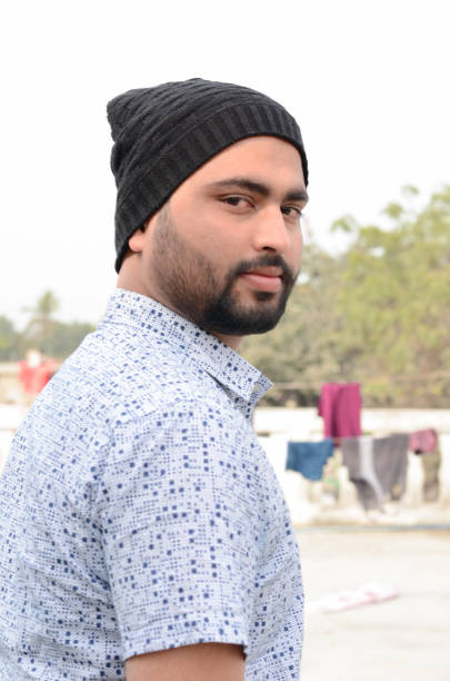 istock Young man looking at camera in winter outdoor scene 1177392275