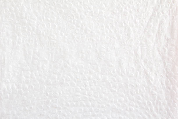 White crumpled paper napkin with pimpled surface texture background.