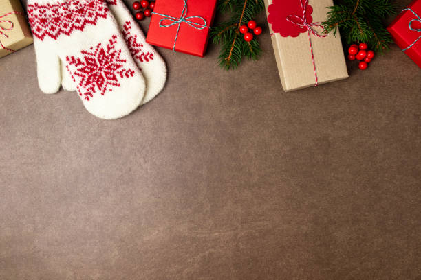 istock Christmas background with gift box, christmas tree, mittens and decorations on stone background. Top view 1177396517