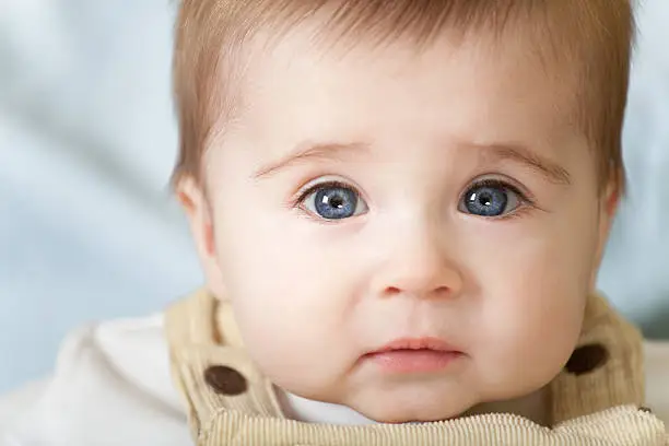 Photo of Portrait of pensive blue-eyes baby