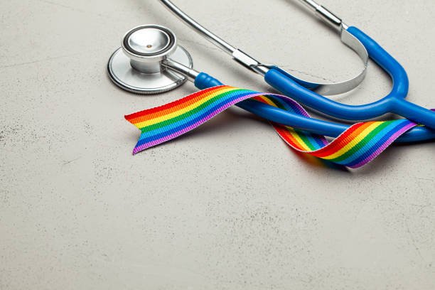 stethoscope and lgbt rainbow ribbon pride tape symbol. medical support after sex reassignment surgery. grey background. copy space for text. - stethoscope blue healthcare and medicine occupation imagens e fotografias de stock