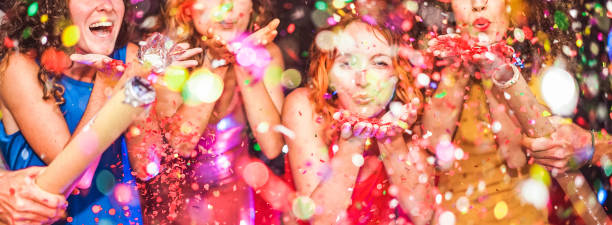 istock Young friends having party throwing confetti - Young people celebrating on weekend night - Entertainment, fun, new year's eve, nightlife, holidays, concept - Focus on red hair girl hands 1177401939