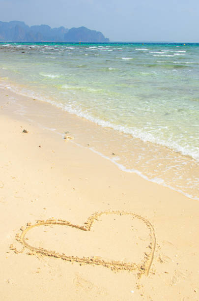 heart love beach heart painted in the sand on a beach of some tropical island koh poda stock pictures, royalty-free photos & images