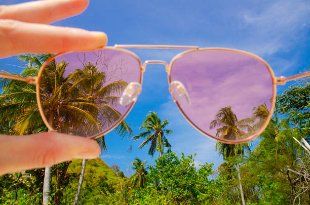 Rose sunglasses against tropical thai island. Optimism. Happiness