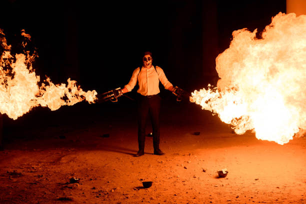istock Halloween man in costume with flamethrower in his hands. Devil makeup on face 1177403797