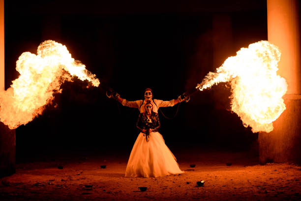 istock Halloween couple standing with flamethrower in hands. big fire 1177403871