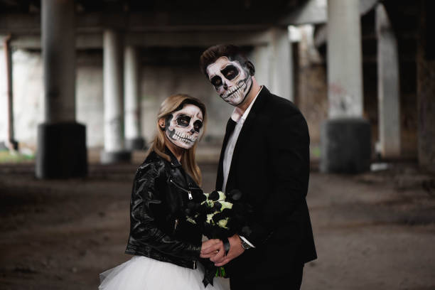 istock Halloween couple. Dressed in wedding clothes romantic zombie 1177404453