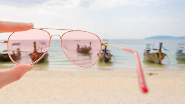 istock Pink sunglasses against tropical island 1177404505
