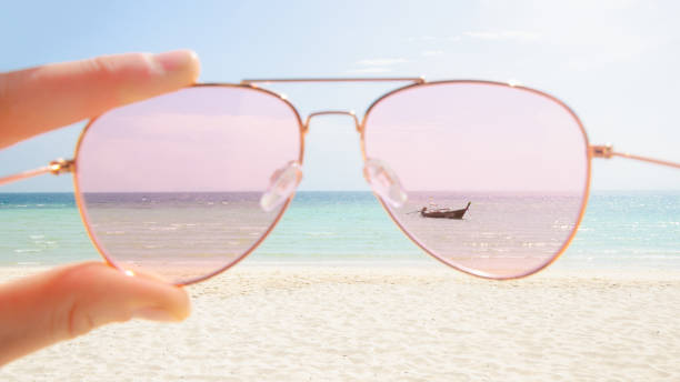 istock Pink sunglasses against tropical island 1177404569