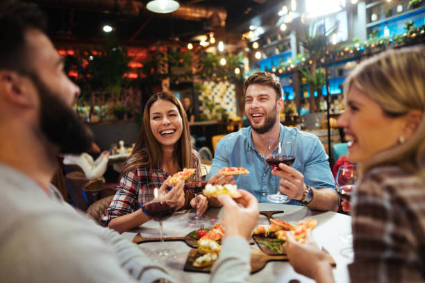 istock Group of friends enjoying red wine in a restaurant 1177404613