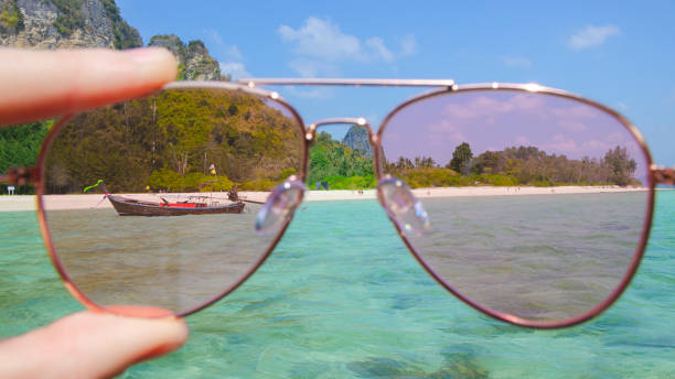 istock Pink sunglasses against tropical island 1177404867