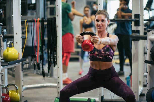 istock Young woman doing kettlebell exercise at gym 1177404930