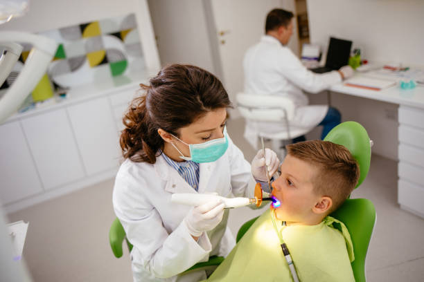 istock Boy receiving dental filling drying procedure 1177406130