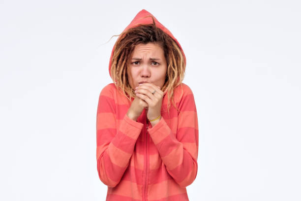 istock Young woman trying to get warm blowing on her hands. 1177406172