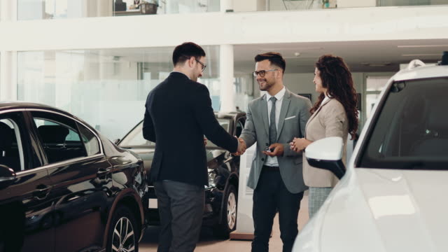 Attractive couple buying new car