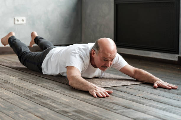 istock Senior hispanic man doing the Shalabhasana on exercise mat 1177407721