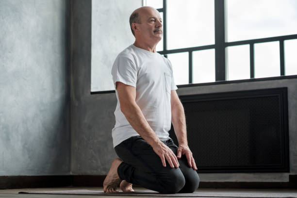 istock Senior hispanic man practicing yoga at home in vajrasana pose 1177408846