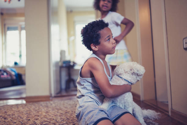 istock Mixed race siblings playing with their dog at home 1177409281