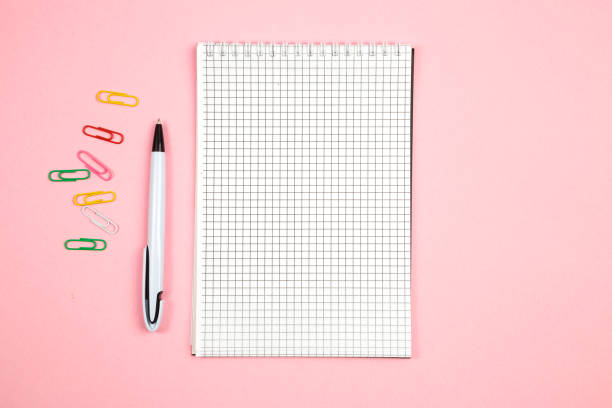 istock paper notebook with pen on pink isolated background. top view. flat lay . mockup 1177409431