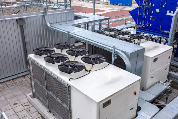 Photo of External infrastructure of the microclimate support system at a large industrial site. Air pipelines inlet and exhaust. Fans and air conditioning. Systems of control of pressure, humidity, temperature
