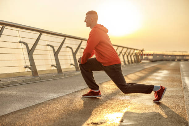istock Strong handsome young man stretching his legs 1177410539