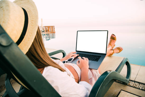 istock Young woman using laptop computer on vacation in luxury resort 1177411115