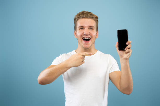 istock Caucasian young man's half-length portrait on blue background 1177411328