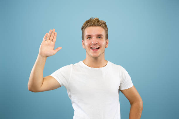 istock Caucasian young man's half-length portrait on blue background 1177411436