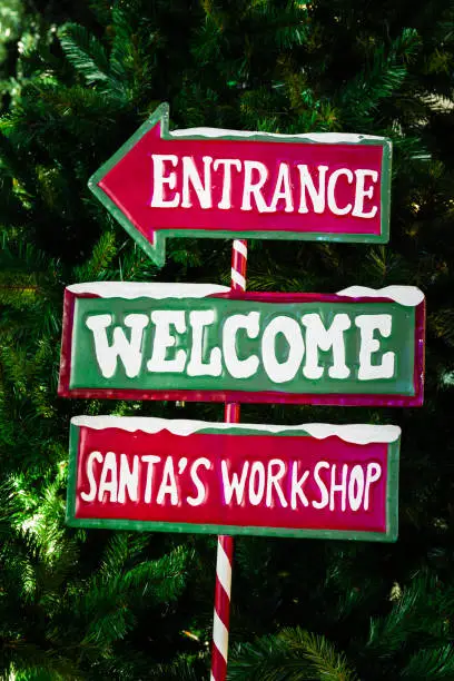 North Pole directional sign saying "Entrance, Welcome, Santa's Workshop"