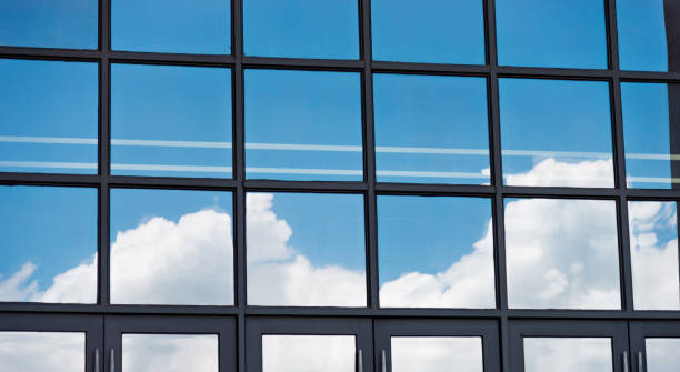 istock Blue sky reflected on wall of modern office building 1177413097