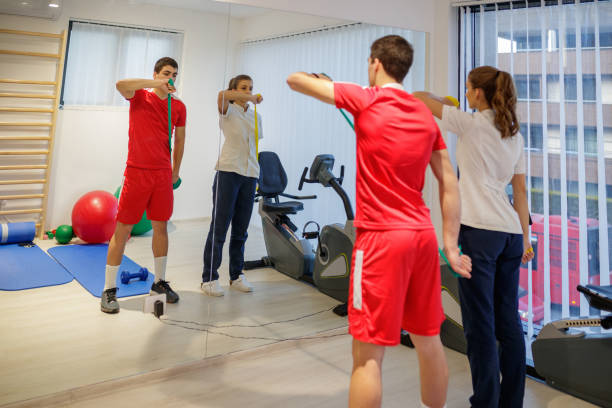 istock Standing by her patient and showing exercise with rubber band 1177415773