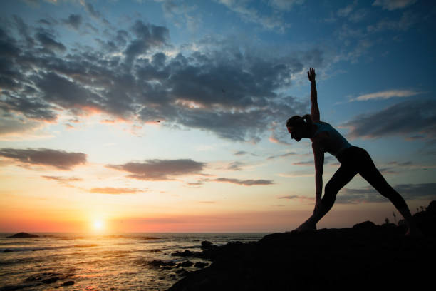 istock Fitness woman doing exercises on the ocean during sunset. 1177417398